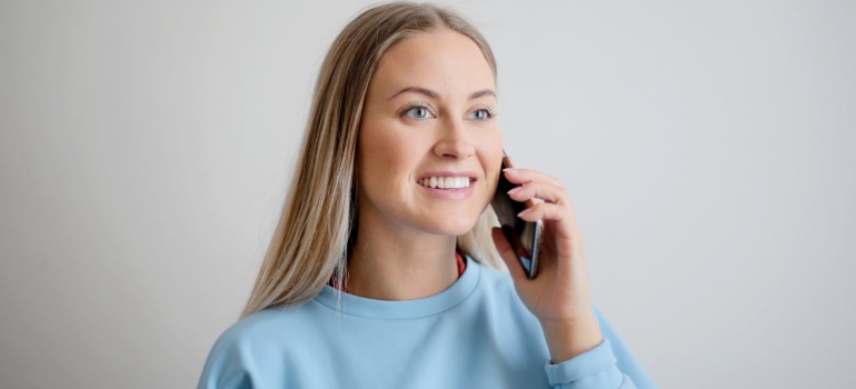 woman calling a moving company to book white glove moving service Los Angeles