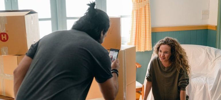 Boyfriend taking photo of cheerful girlfriend