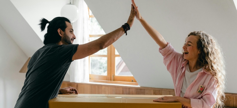 Exited diverse couple relocating in new apartment