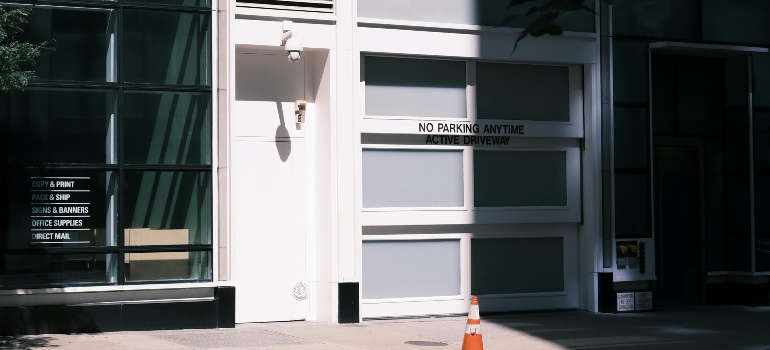 Movers in Glendale CA carefully handle every detail, from tight spaces to tricky access near an urban no parking sign on a modern building.
