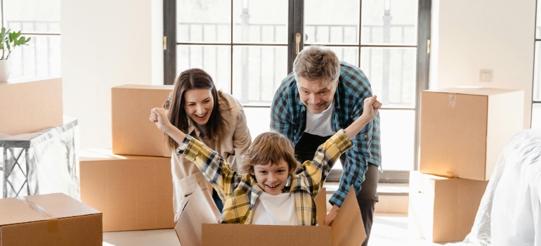A family moving boxes in the new apartment.
