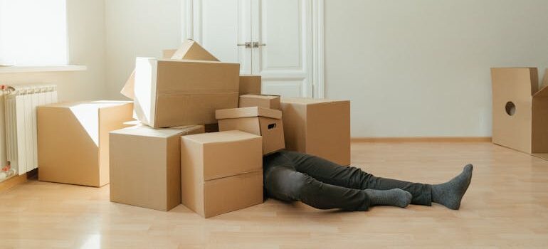 person buried under boxes