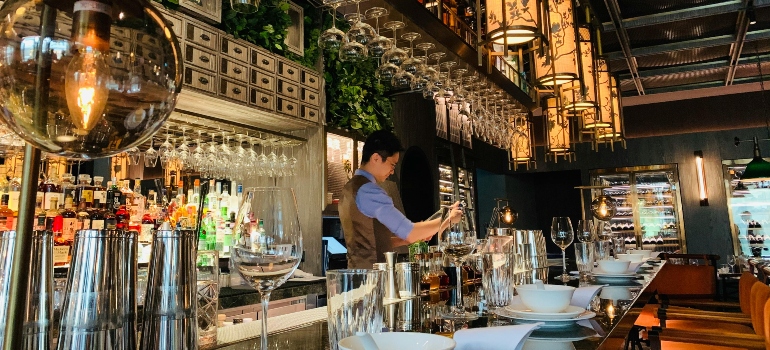 Bartender working at bar counter in oriental restaurant