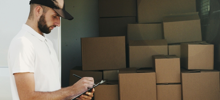 A man is creating a checklist for a new relocation.