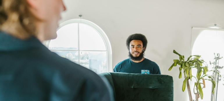 Movers carefully handling and moving big, bulky furniture during a residential move in Woodland Hills.