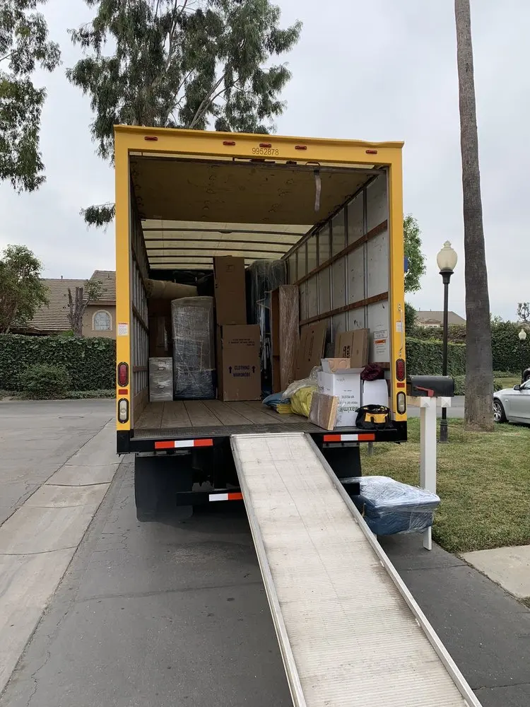 Movers in Los Angeles loading furniture into a truck, showcasing hourly rates