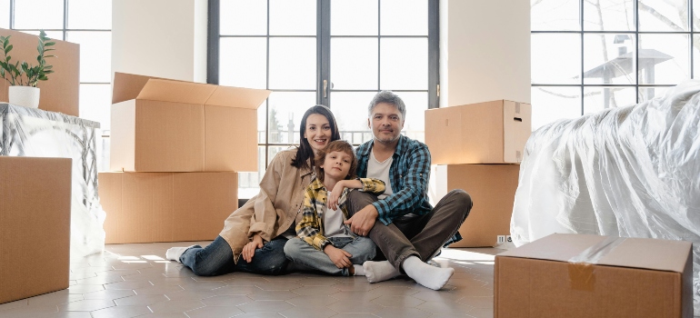 Family sitting on the floor after the move.