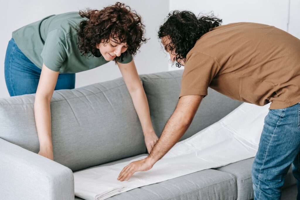 a couple packing a couch and preparing for a move smooth move to Calabasas