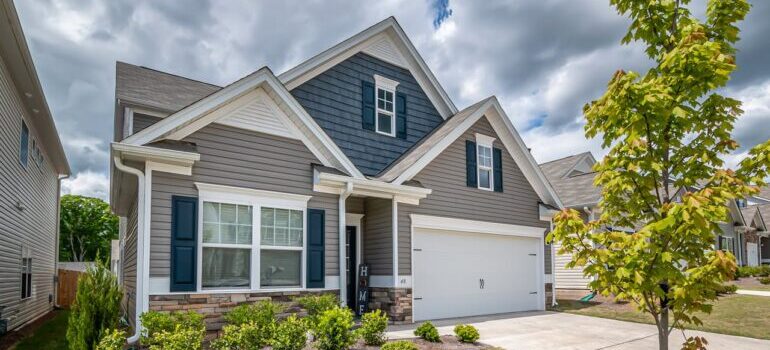 A White and Gray Wooden House Under Cloudy Sky