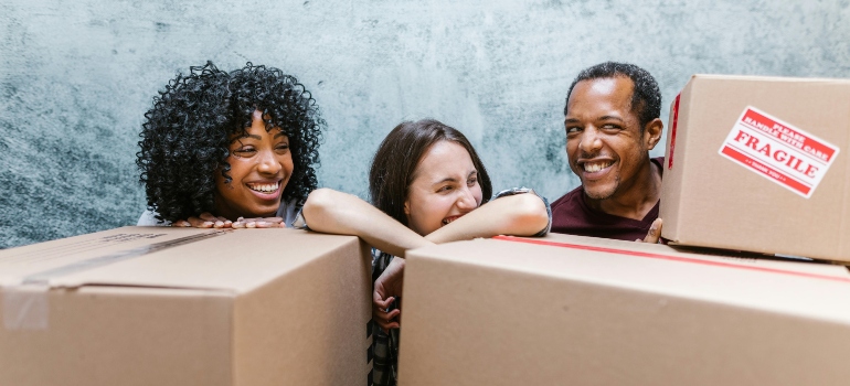 three people lying on the boxes