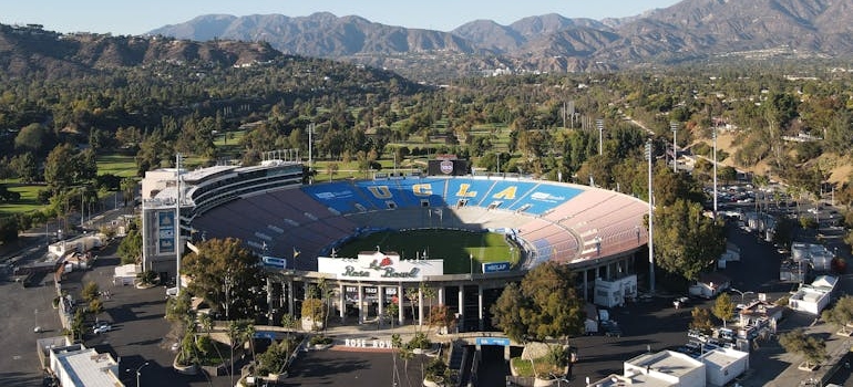 Aerial view of the Rose Bowl stadium and surrounding parking areas, relevant to moving your business from Pasadena to West Hollywood.