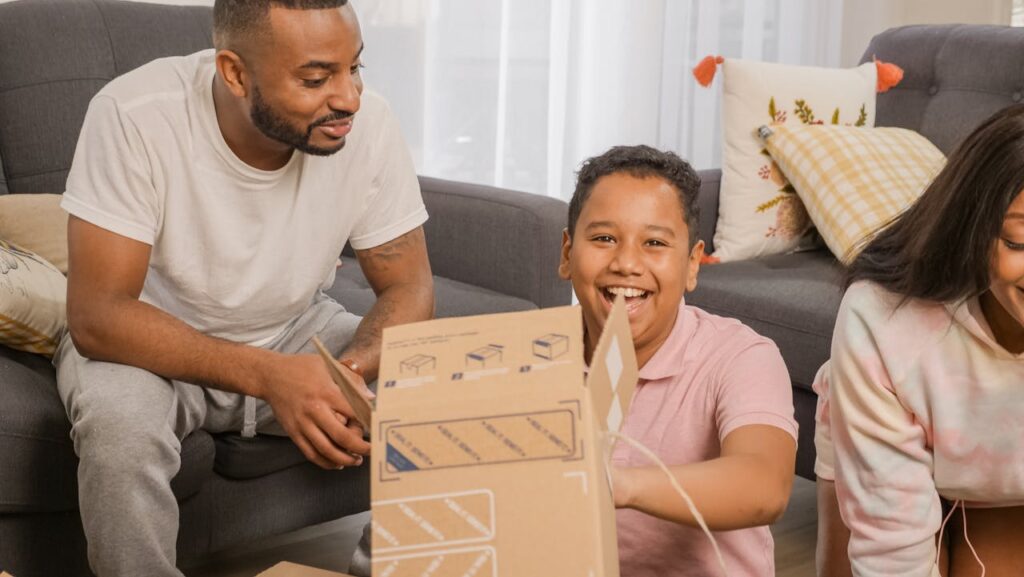 a family playing on a couch after moving high-value furniture from Beverly Hills to the San Fernando Valley