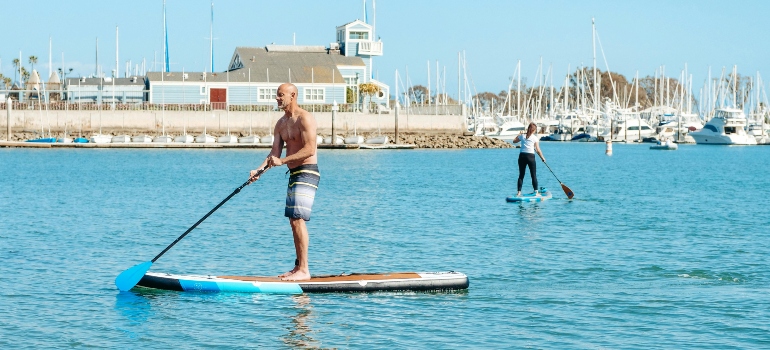 Man paddleboarding in Marina Del Rey enjoying water activities and scenic views