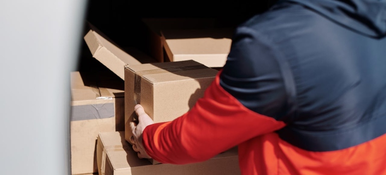 Person loading boxes into a van 