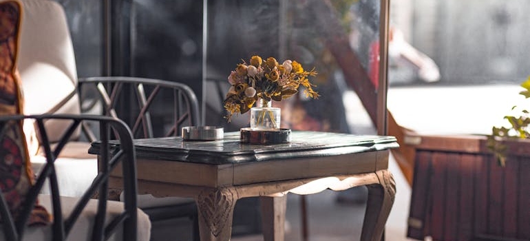 Small table with decor near a window, reflecting a finished setup after Moving High-Value Furniture From Beverly Hills to the San Fernando Valley.
