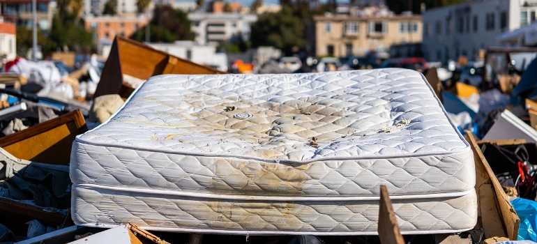 old mattress on a pile of junk